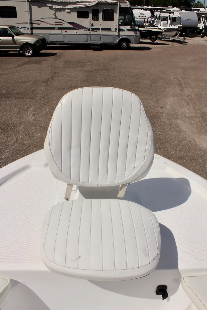 Slide: The Image of White seating on 2002 Cobia 191 Bay boat, parked in a lot. - 20