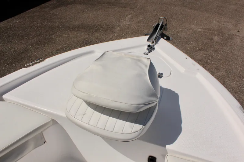 Slide: The Image of 2002 Cobia 191 Bay boat bow with white cushioned seat and anchor. - 21