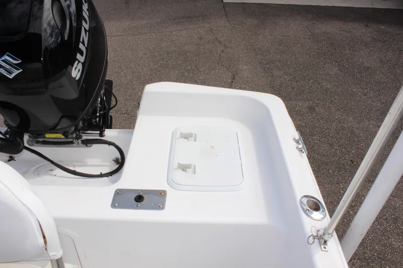 Slide: The Image of 2002 Cobia 191 Bay boat with Suzuki outboard motor, rear deck view. - 8