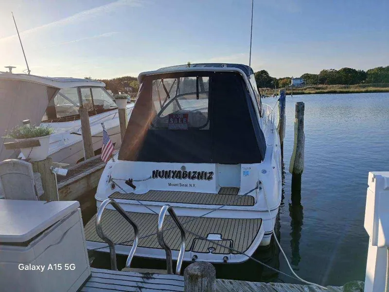 Slide: The Image of 2002 Regal Commodore 3060 boat docked at marina, rear view, sunny day. - 1