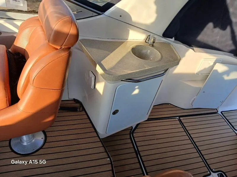 Slide: The Image of 2002 Regal Commodore 3060 boat interior with leather seating and compact sink. - 11