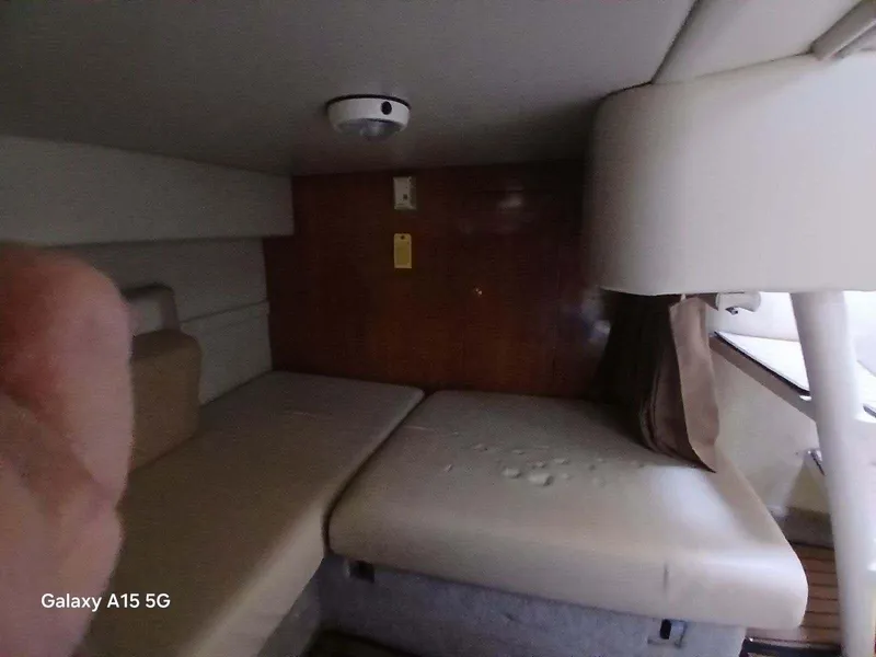 Slide: The Image of Interior cabin of 2002 Regal Commodore 3060 boat with beige seating. - 18