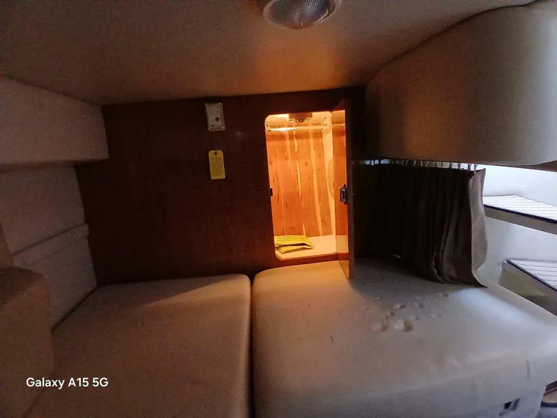 Slide: The Image of Interior cabin of 2002 Regal Commodore 3060 boat with cozy sleeping area. - 19