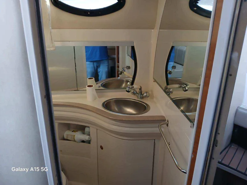 Slide: The Image of 2002 Regal Commodore 3060 boat bathroom with sink and mirror. - 21