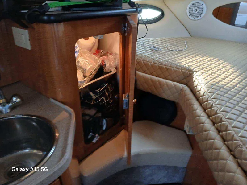 Slide: The Image of Interior of 2002 Regal Commodore 3060 boat with cabin and kitchenette. - 27