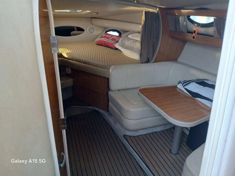 Slide: The Image of Interior of 2002 Regal Commodore 3060 yacht with cozy seating and bed. - 29