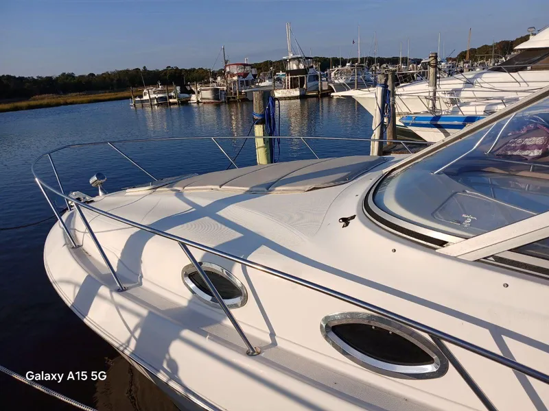 Slide: The Image of 2002 Regal Commodore 3060 yacht docked at marina under clear sky. - 3