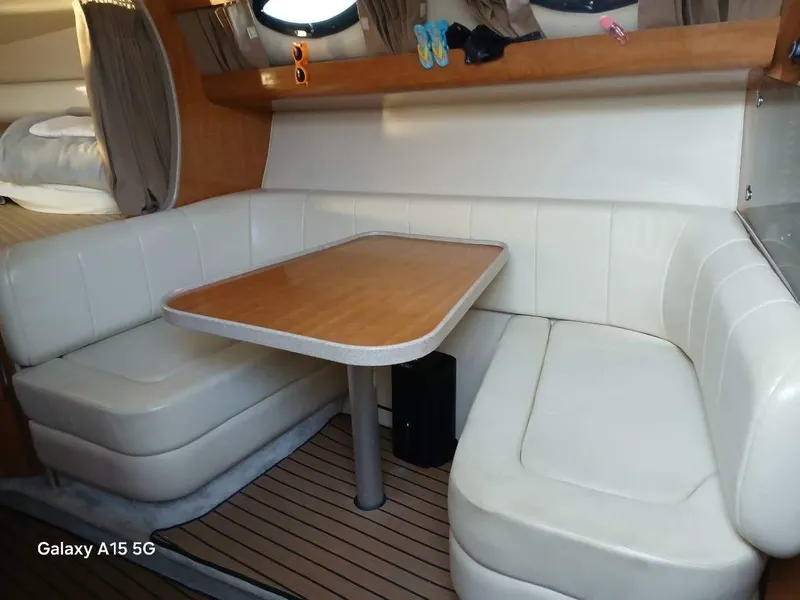 Slide: The Image of Interior of 2002 Regal Commodore 3060 with white leather seating and wooden table. - 31