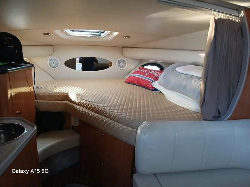 Slide: The Image of Cozy cabin interior of 2002 Regal Commodore 3060 with bed and porthole. - 32