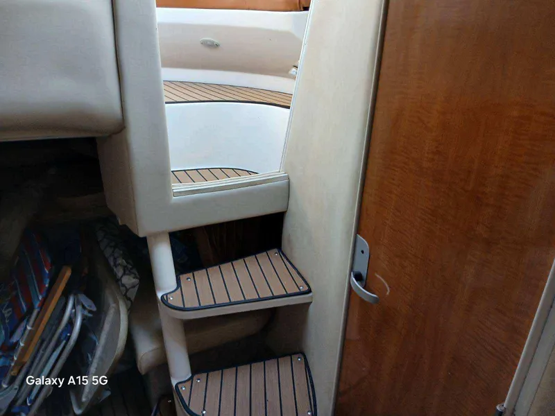 Slide: The Image of Interior stairs of 2002 Regal Commodore 3060 yacht with wooden accents. - 33