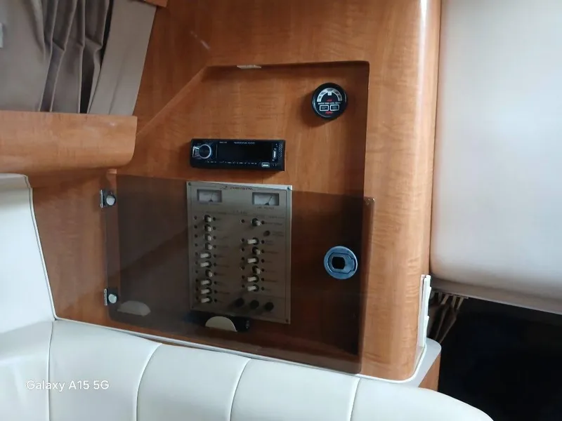 Slide: The Image of Control panel of 2002 Regal Commodore 3060 boat with wood finish and switches. - 34