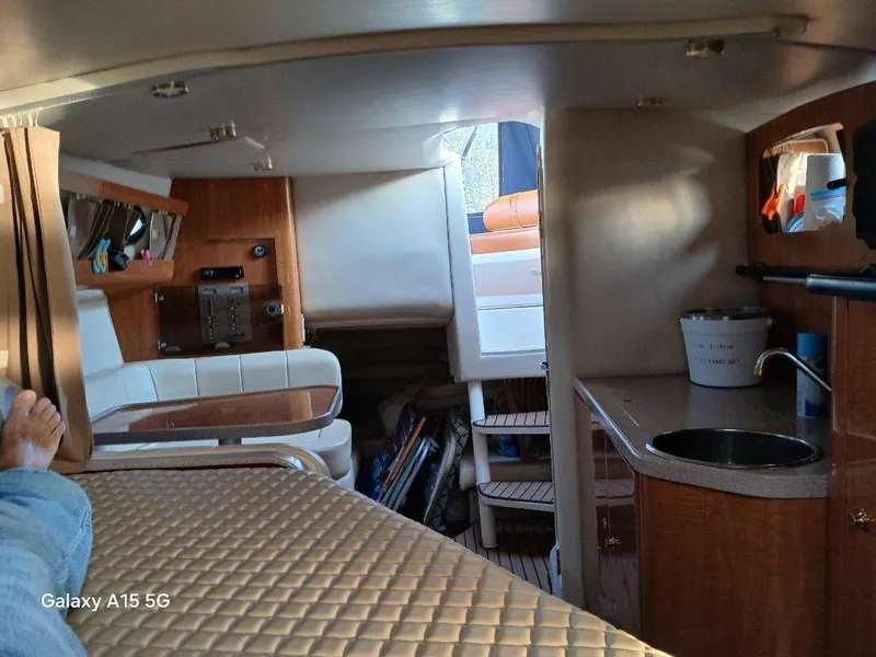 Slide: The Image of Interior of 2002 Regal Commodore 3060 boat with seating, kitchenette, and storage. - 35