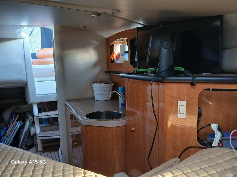Slide: The Image of Interior of 2002 Regal Commodore 3060 yacht with kitchenette and TV. - 36