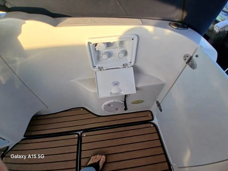 Slide: The Image of Regal Commodore 3060 boat interior, 2002 model, featuring wooden flooring and storage compartment. - 40