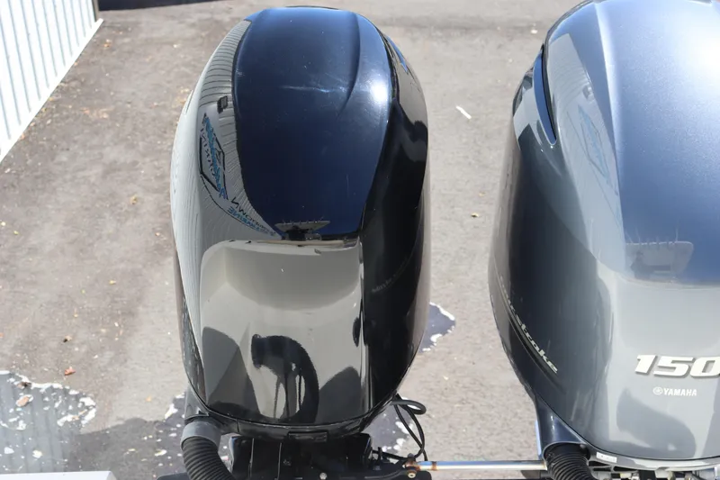 Slide: The Image of Twin Yamaha outboard motors on a 2012 Cobia 256 CC boat. - 10