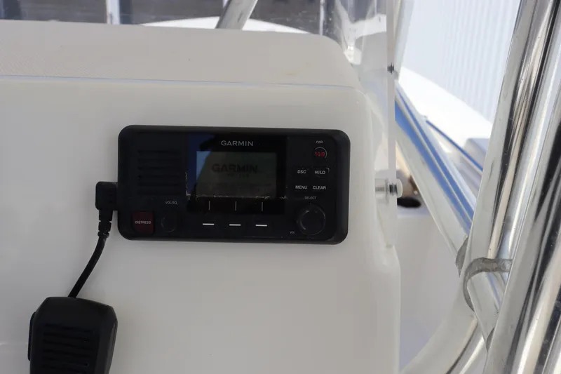 Slide: The Image of Garmin marine radio on 2012 Cobia 256 CC boat dashboard. - 12