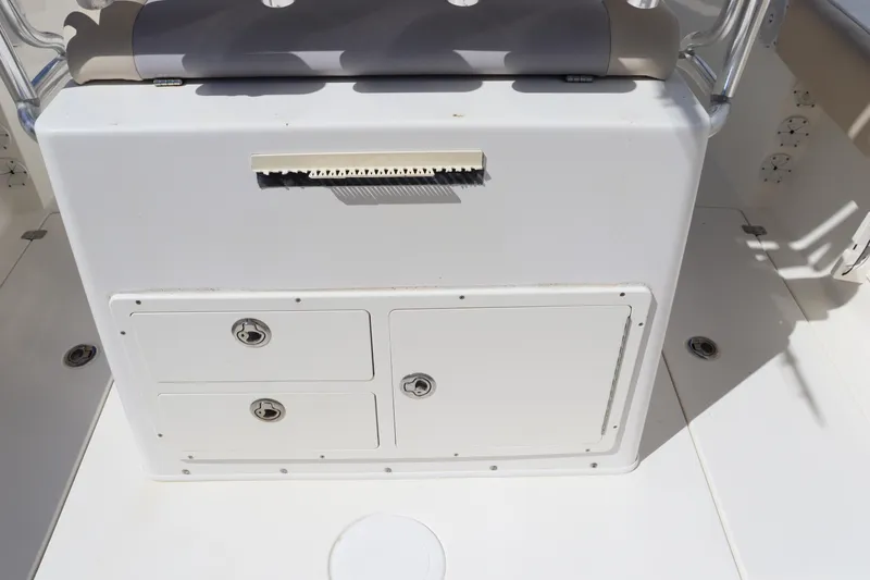 Slide: The Image of 2012 Cobia 256 CC boat storage compartments and seating area. - 18