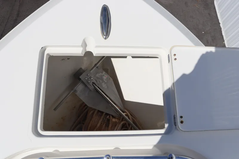 Slide: The Image of Anchor storage compartment on 2012 Cobia 256 CC boat. - 24