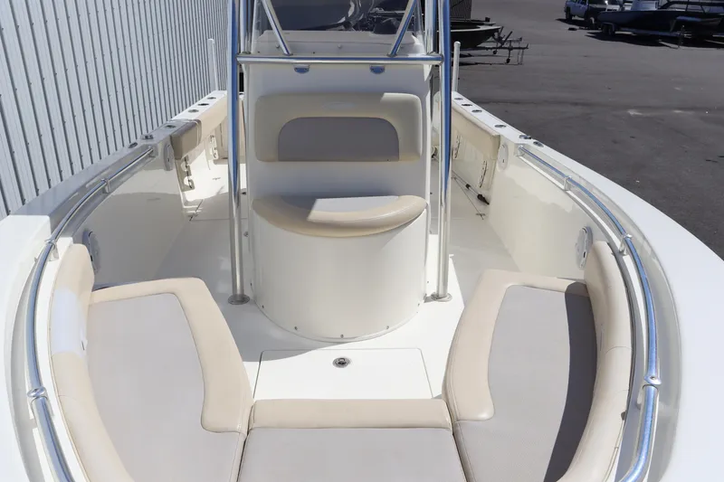 Slide: The Image of 2012 Cobia 256 CC boat interior with cushioned seating and center console. - 25