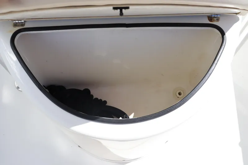 Slide: The Image of Open storage compartment on a 2012 Cobia 256 CC boat. - 28