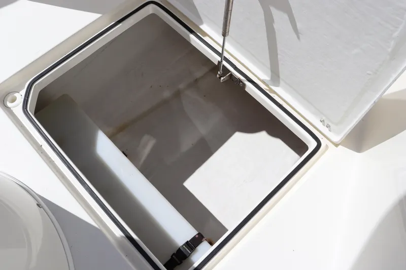Slide: The Image of Open storage compartment on 2012 Cobia 256 CC boat. - 29