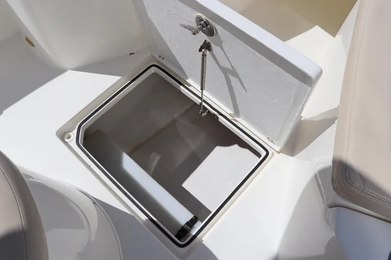 Slide: The Image of Open storage compartment on 2012 Cobia 256 CC boat. - 30
