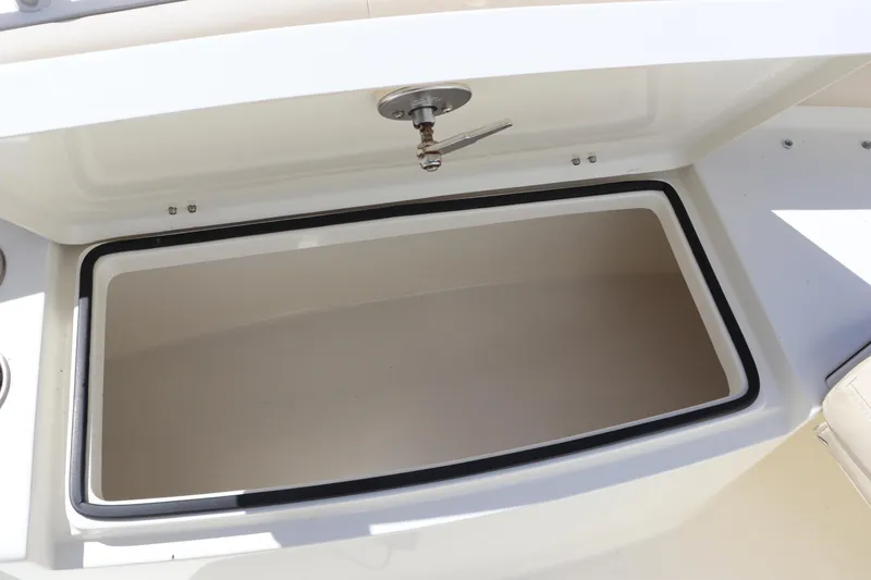 Slide: The Image of Open storage compartment on a 2012 Cobia 256 CC boat. - 31