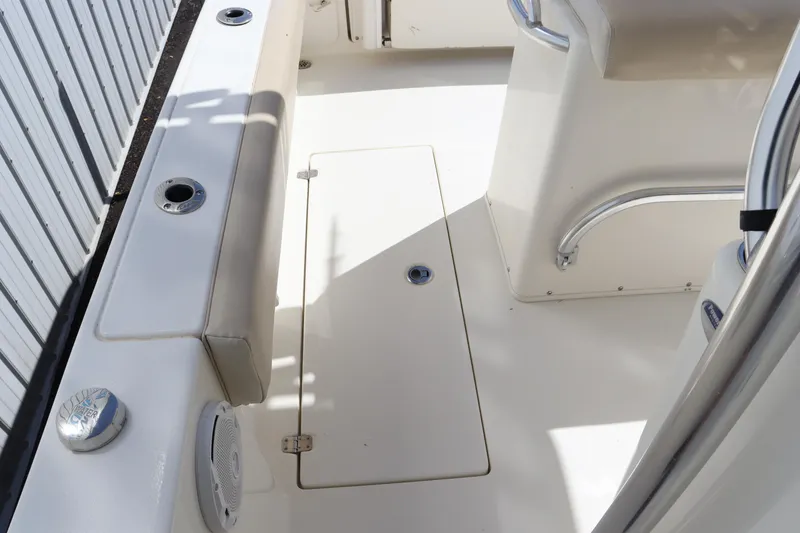 Slide: The Image of 2012 Cobia 256 CC boat deck with storage hatch and seating area. - 35