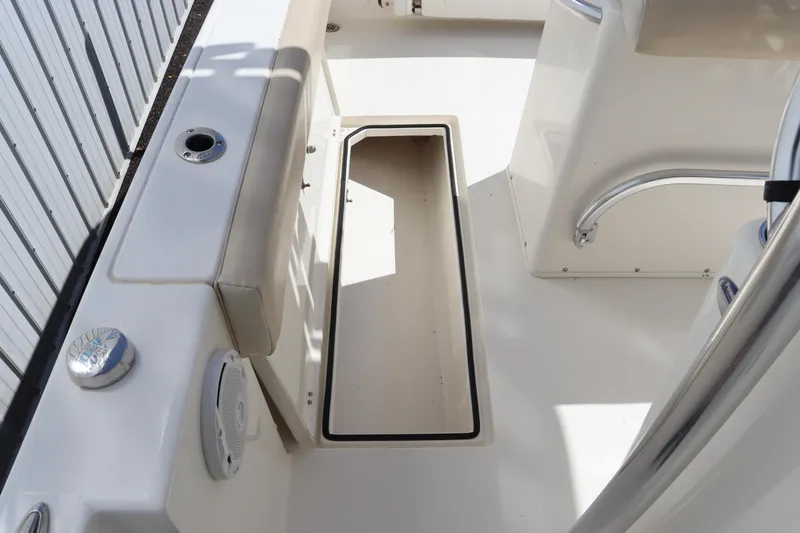 Slide: The Image of 2012 Cobia 256 CC boat interior with open storage compartment. - 36