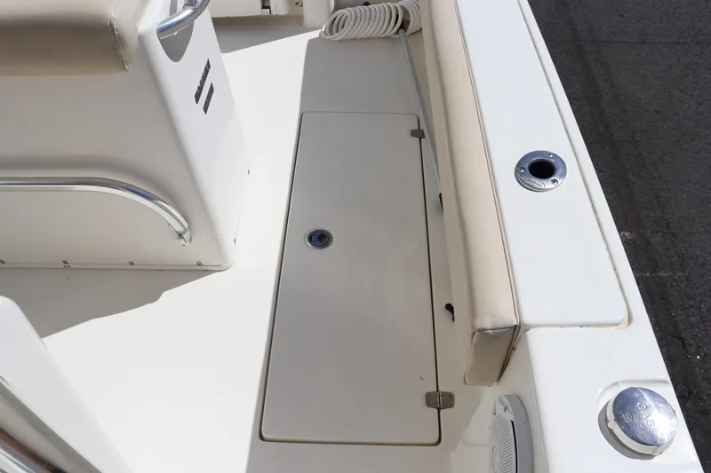 Slide: The Image of 2012 Cobia 256 CC boat deck with storage compartment and seating area. - 38