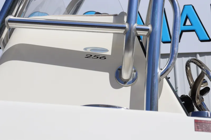Slide: The Image of Close-up of 2012 Cobia 256 CC boat console with stainless steel railings. - 4