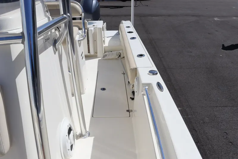 Slide: The Image of 2012 Cobia 256 CC boat deck with stainless steel railings and storage compartments. - 40