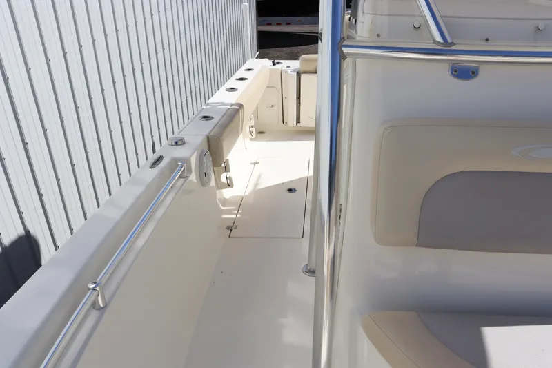 Slide: The Image of 2012 Cobia 256 CC boat interior with seating and railings. - 41