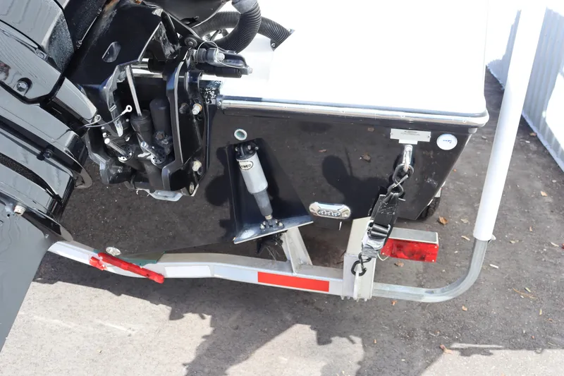 Slide: The Image of 2012 Cobia 256 CC boat trailer hitch and motor detail. - 7