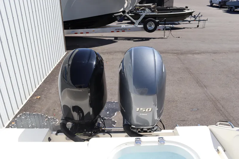 Slide: The Image of 2012 Cobia 256 CC with dual Yamaha outboard motors in a parking lot. - 8