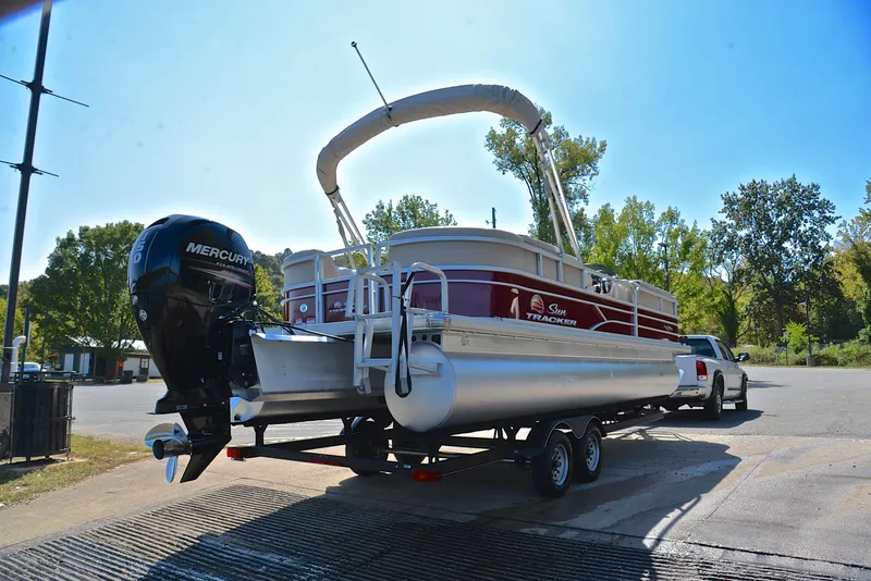 Slide: The Image of 2018 Sun Tracker Party Barge 24 DLX on trailer, parked outdoors. - 14