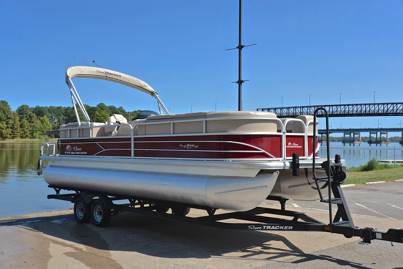 Slide: The Image of 2018 Sun Tracker Party Barge 24 DLX pontoon boat on trailer by a lake. - 16