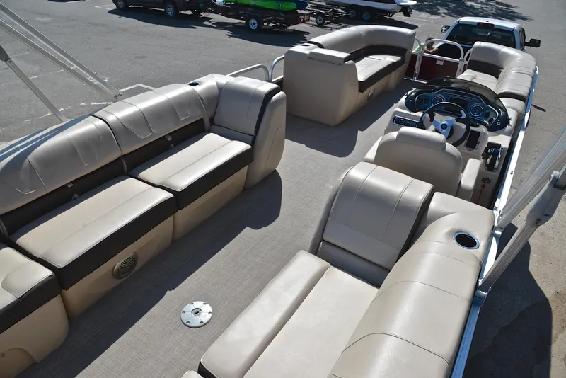 Slide: The Image of 2018 Sun Tracker Party Barge 24 DLX interior with spacious seating and helm. - 19