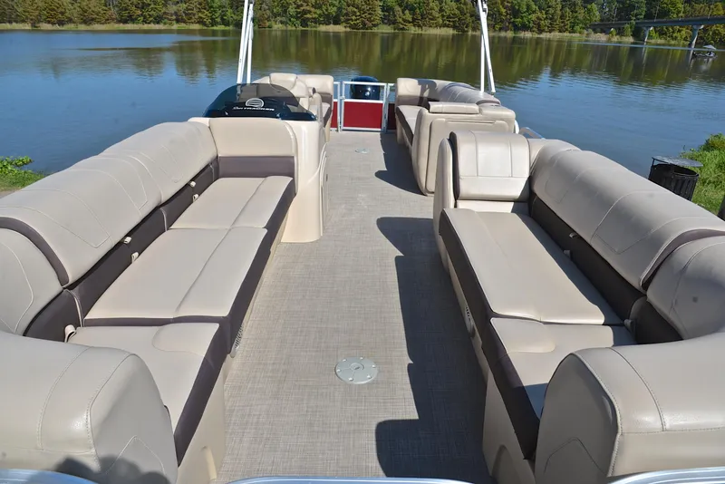 Slide: The Image of 2018 Sun Tracker Party Barge 24 DLX interior with spacious seating on a calm lake. - 20
