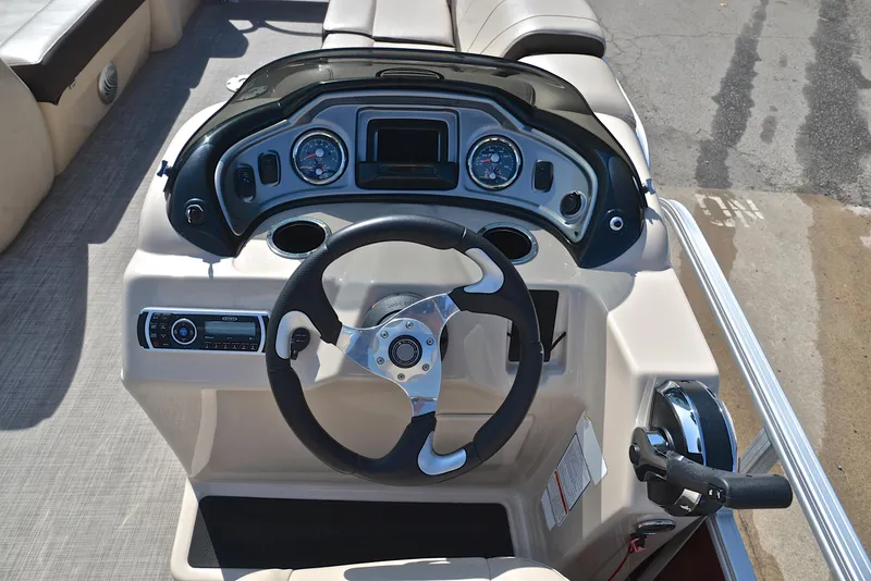 Slide: The Image of 2018 Sun Tracker Party Barge 24 DLX dashboard with steering wheel and controls. - 25