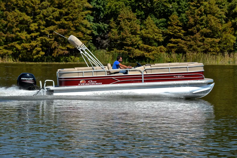 Slide: The Image of 2018 Sun Tracker Party Barge 24 DLX pontoon boat cruising on a lake. - 3