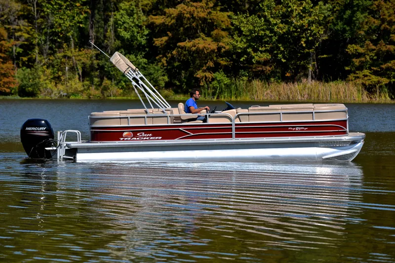 Slide: The Image of 2018 Sun Tracker Party Barge 24 DLX pontoon boat cruising on a serene lake. - 6