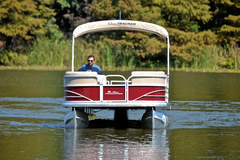 Slide: The Image of 2018 Sun Tracker Party Barge 24 DLX pontoon boat on a serene lake. - 9