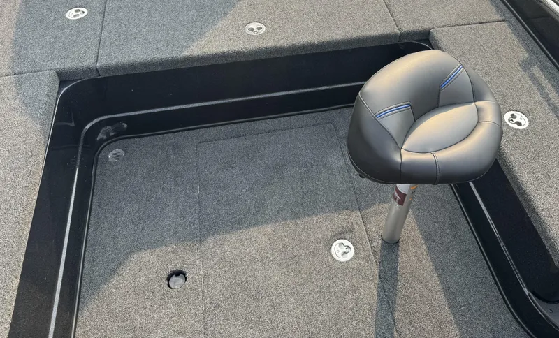 Slide: The Image of 2024 Nitro ZV20 boat interior with gray seating and carpeted flooring. - 13
