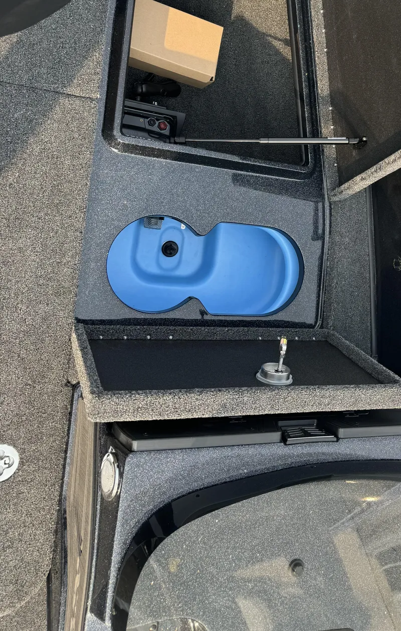 Slide: The Image of 2024 Nitro ZV20 boat interior with blue storage compartment and textured flooring. - 24