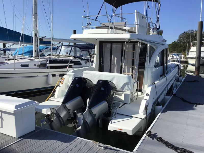 Slide: The Image of 2024 Beneteau Antares 11 Fly yacht docked with twin outboard engines. - 1