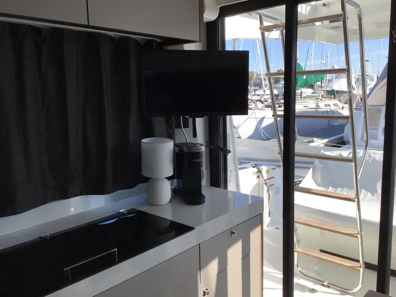 Slide: The Image of Interior of 2024 Beneteau Antares 11 Fly yacht with modern kitchen and marina view. - 10