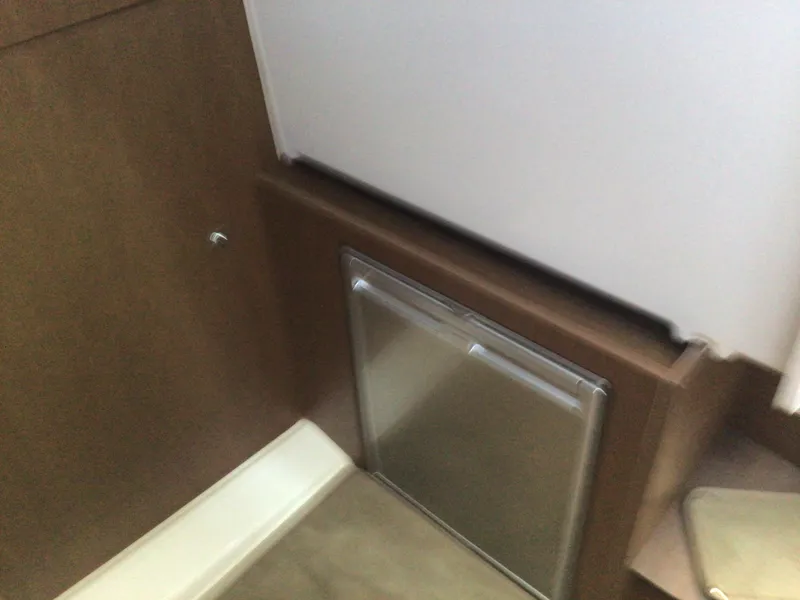 Slide: The Image of 2024 Beneteau Antares 11 Fly interior with compact stainless steel appliance. - 15