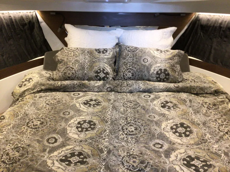 Slide: The Image of Luxurious cabin interior of 2024 Beneteau Antares 11 Fly with patterned bedding. - 16