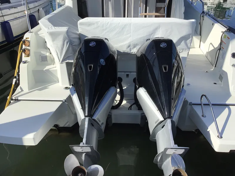 Slide: The Image of 2024 Beneteau Antares 11 Fly with dual outboard engines at dock. - 2